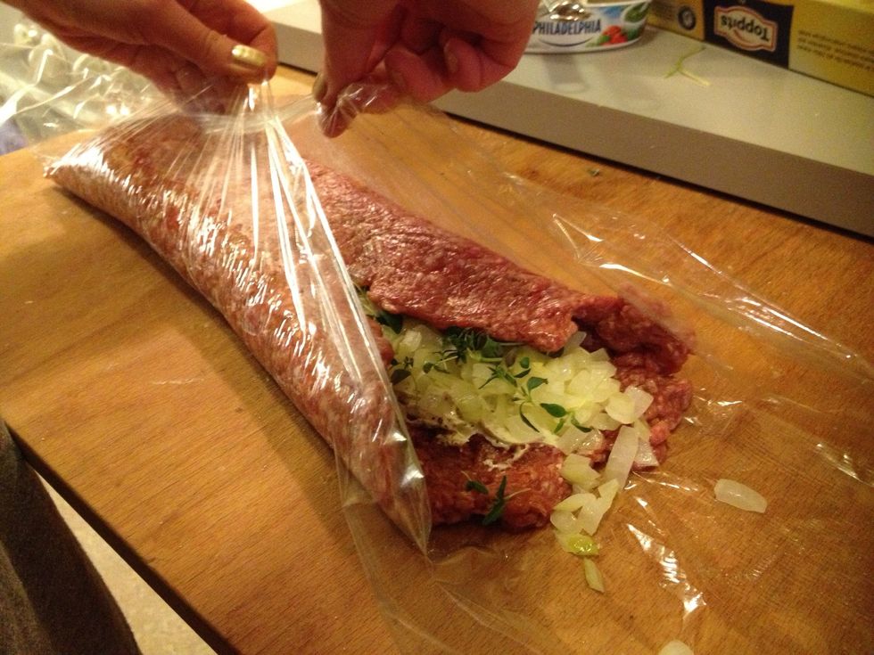 I also added fresh thyme. Then use the plastic to roll the meat.