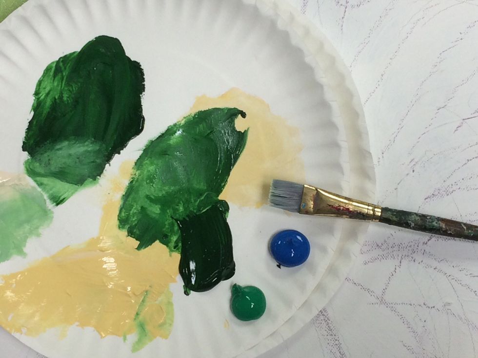 I am adding water to my paint brush to make the paint thinner so it spreads smoothly over the canvas. Use a medium sized brush.