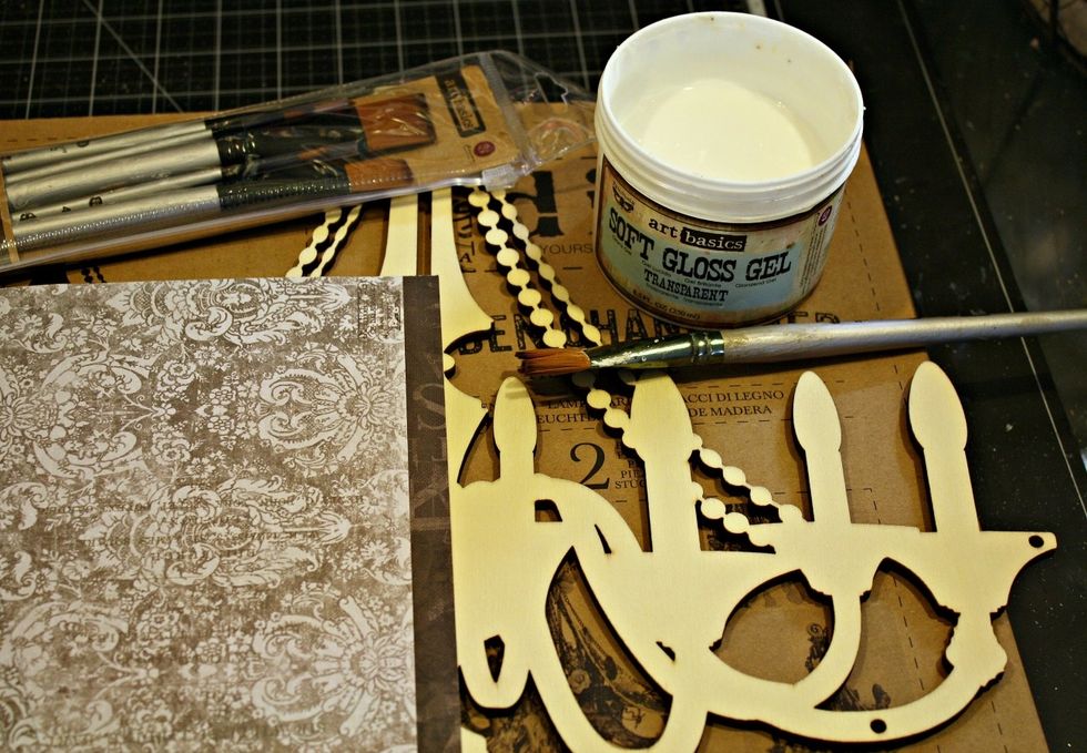 I am gathering all of my supplies to get started. I will be using the new wooden DIY chandeliers , Soft Gloss Gel, Salvage District papers, Chalkboard Paint, and Glass Glitter to create my background.
