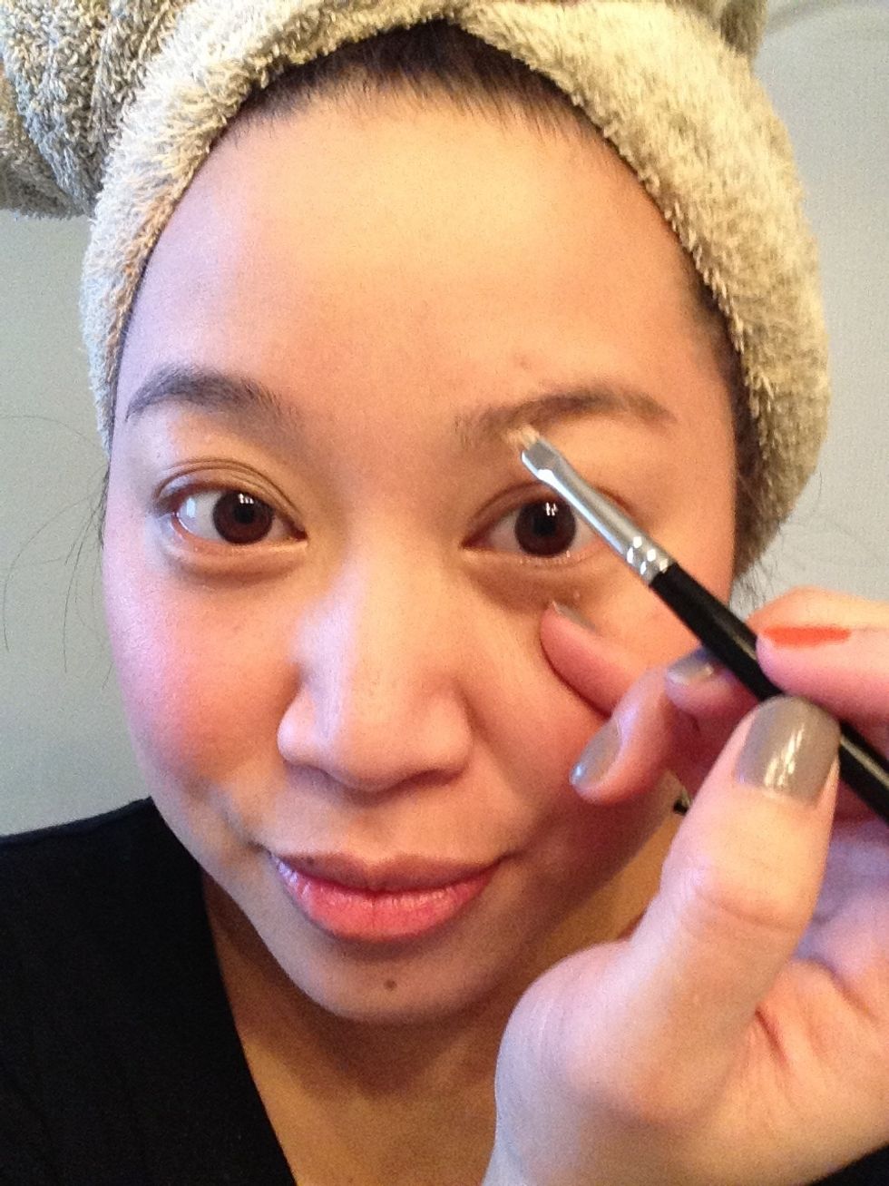 I am using a soft brown powder from the Benefit BrowZing palette and a slanted brush to stroke the colour into the brow ...
