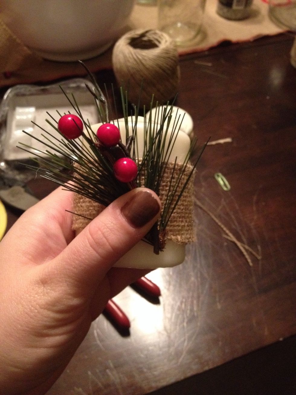 I attached my greenery first to itself to make a very small bouquet of sorts with green floral twist ties, the I pressed the greenery into the bead of hot glue on the burlap.