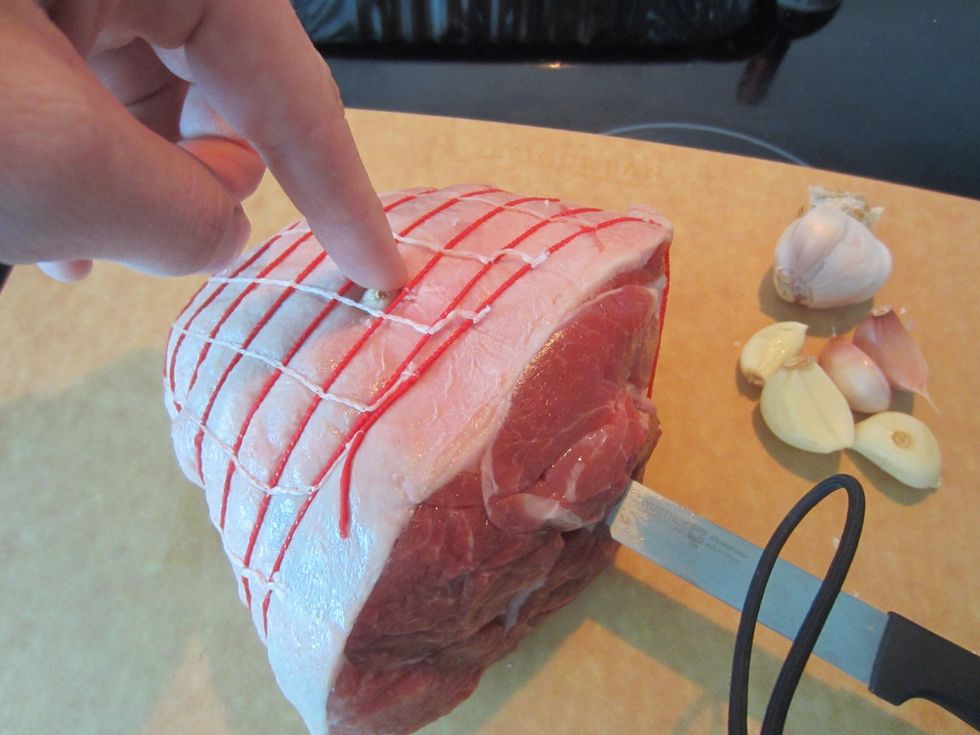 I bought a portion big enough for 3, de boned and strung up by the butcher in whole foods. Poke holes in several different spots through out the cut. Poke in full cloves of garlic towards the middle.