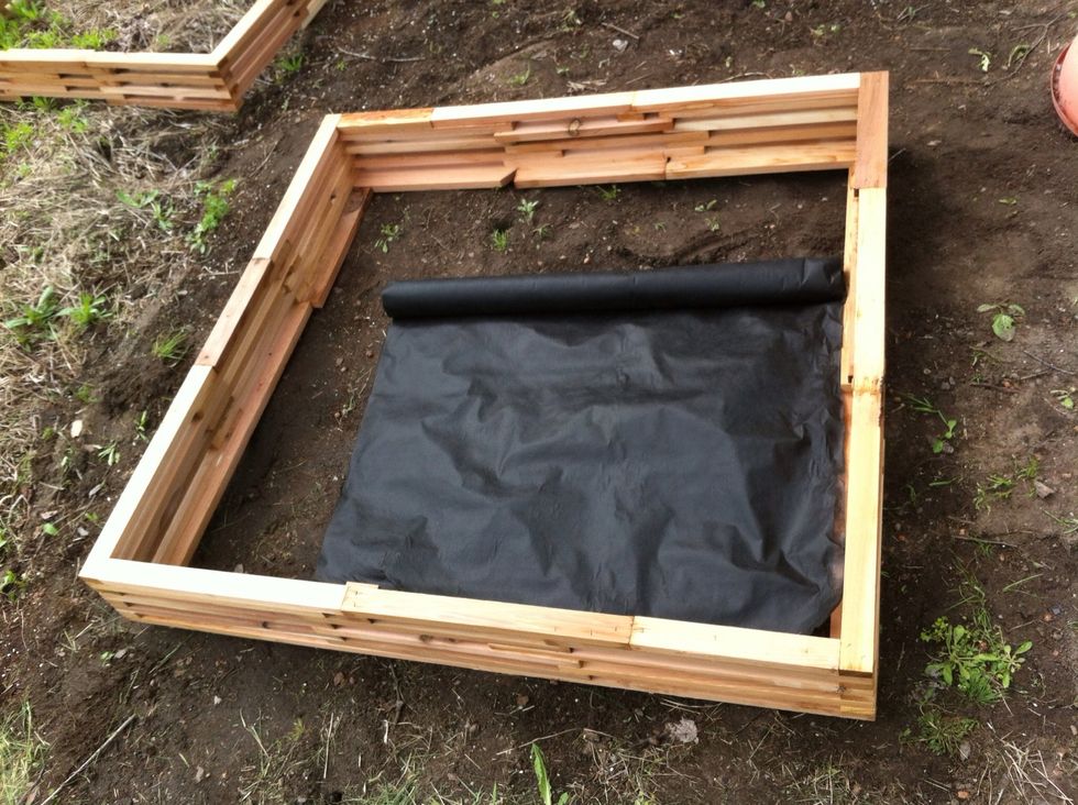 I bought inexpensive landscaping fabric to line the bottom and sides of the boxes. This will help keep the weeds out and soil in.