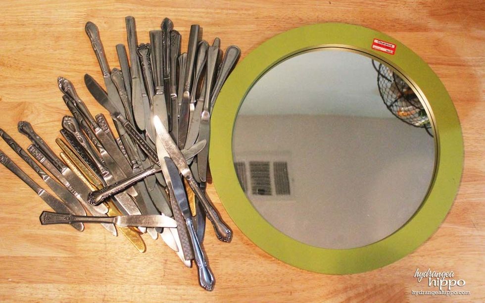 I bought this mirror on clearance at Target for $3.24. At Salvation Army, we spotted several tubs of silverware, each sorted by type, on sale for 5 for $1. The knives were perfect for the mirror!