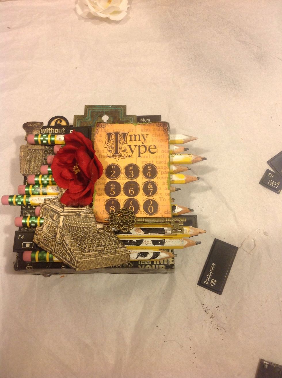 I broke apart an old keyboard and I'm using some of the keys as embellishments.