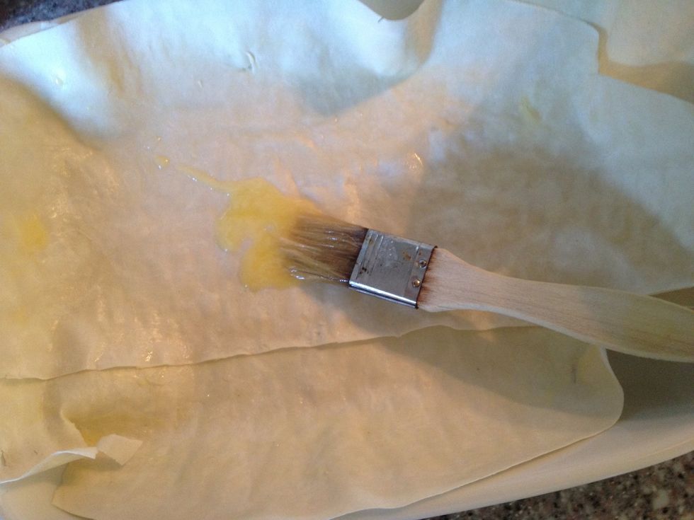 I brushed 2 sheets of filo dough with melted butter on both sides and placed them in a oven proof dish.