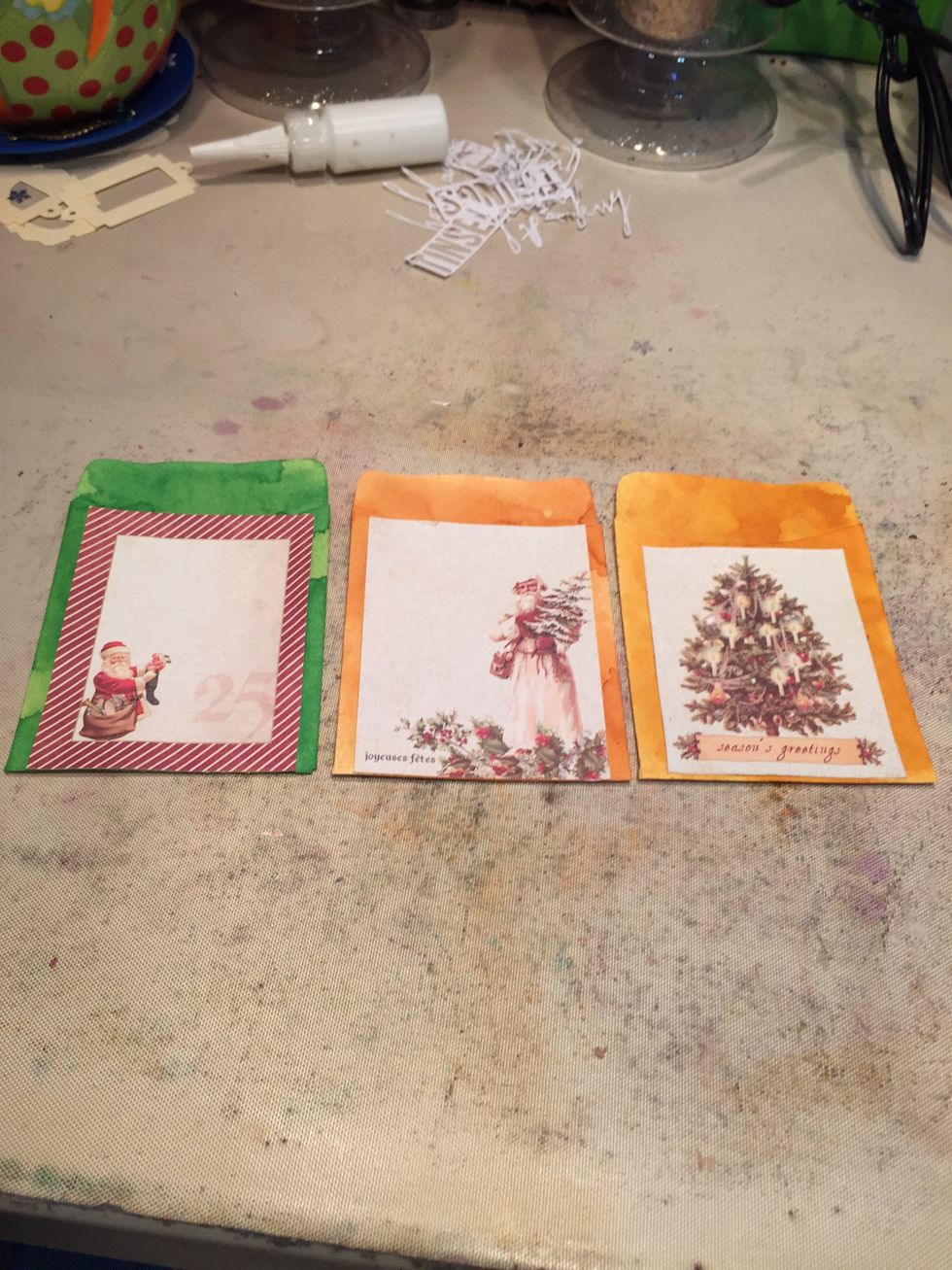 I chose papers that matched the tags going in the pockets, trimmed them, and then glued them on.