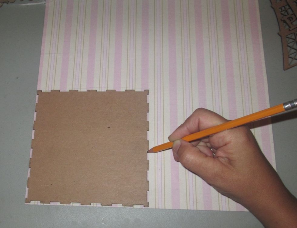 I chose this adhesive fabric for my back groud. Using a pencil, trace within the grooves so you can trim for a perfect fit without covering the notches that will attach to another piece.