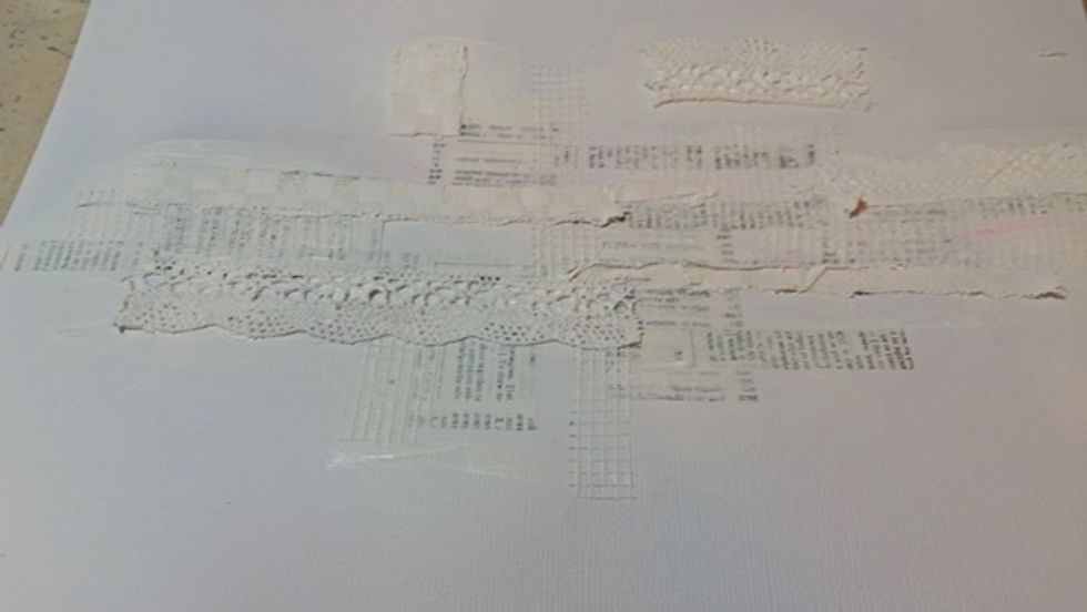 I continued adding lace and other cloth bits after I was happy with my base I covered all my bits with gesso.