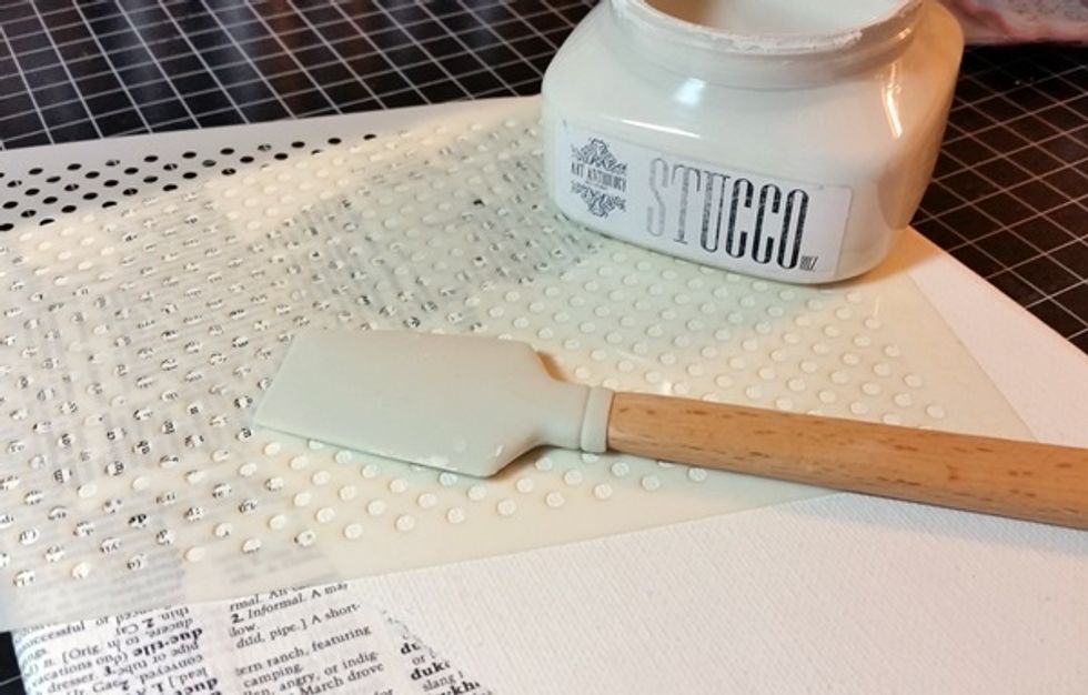 I continued building my background with a layer of stucco through our Dottie Stencil.