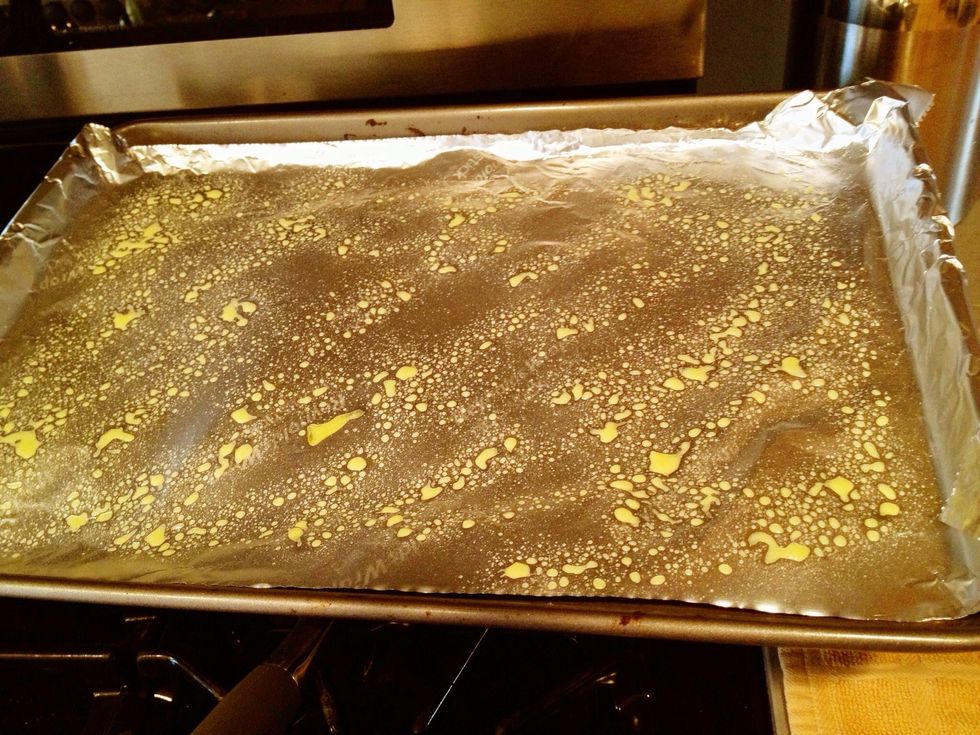 I cover my baking sheet with non-stick foil or parchment paper to make cleaning up easy. Mist the surface with olive oil or apply small amount of oil directly onto the bottom surface + rub it around