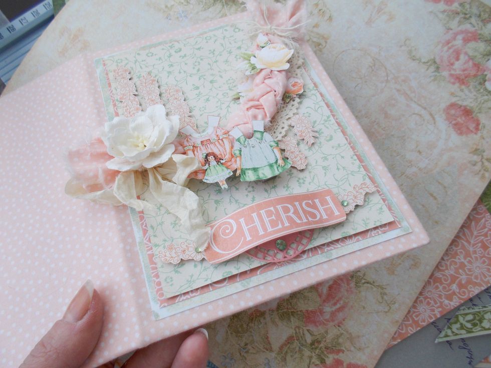 I created 3 layer of main paper, cut some perfect flower and dress prints from the Graphic 45 Precious Memories Collection`s sheets. I used 3D foam tape to get this composition more volume.