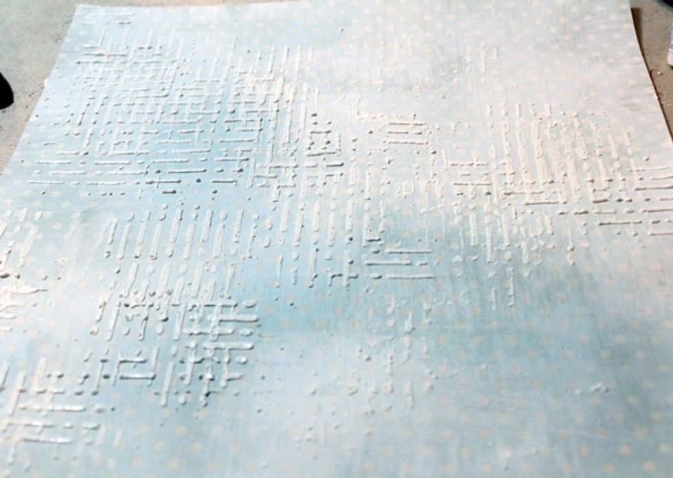 I created a grid texture by adding to layers of the stucco through the stencil, of coarse I dried the vertical layer before adding the horizontal layer.