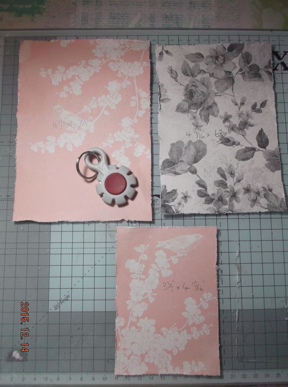 I cut 3 oblongs in sizes 4 7/16" x 6 3/8" , 4 7/8" x 6 7/8" , 3 1/2" x 4 15/16" in my chosen papers. I then distressed the edges.