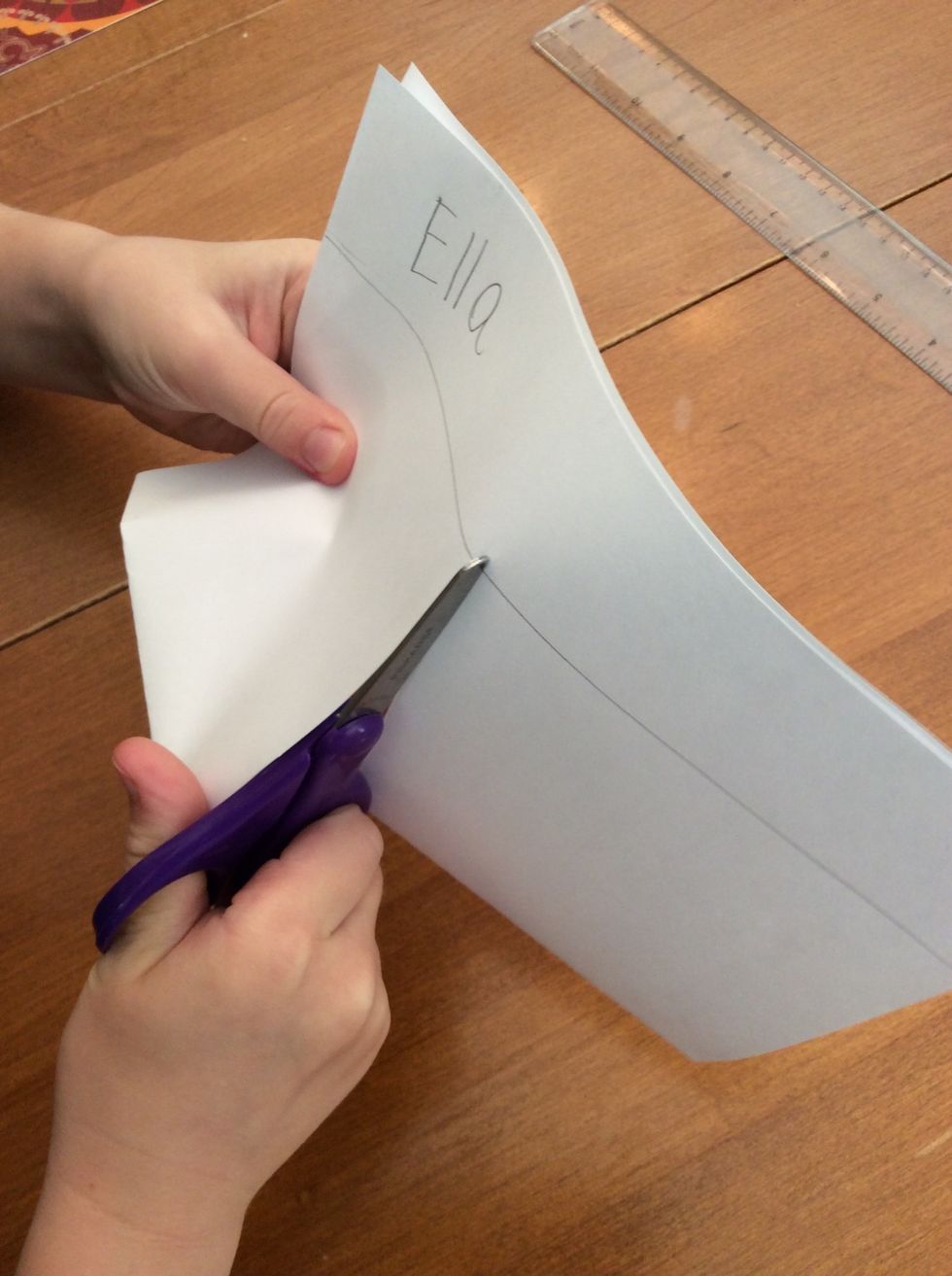 I cut a line in the middle of the paper to make the pant legs.