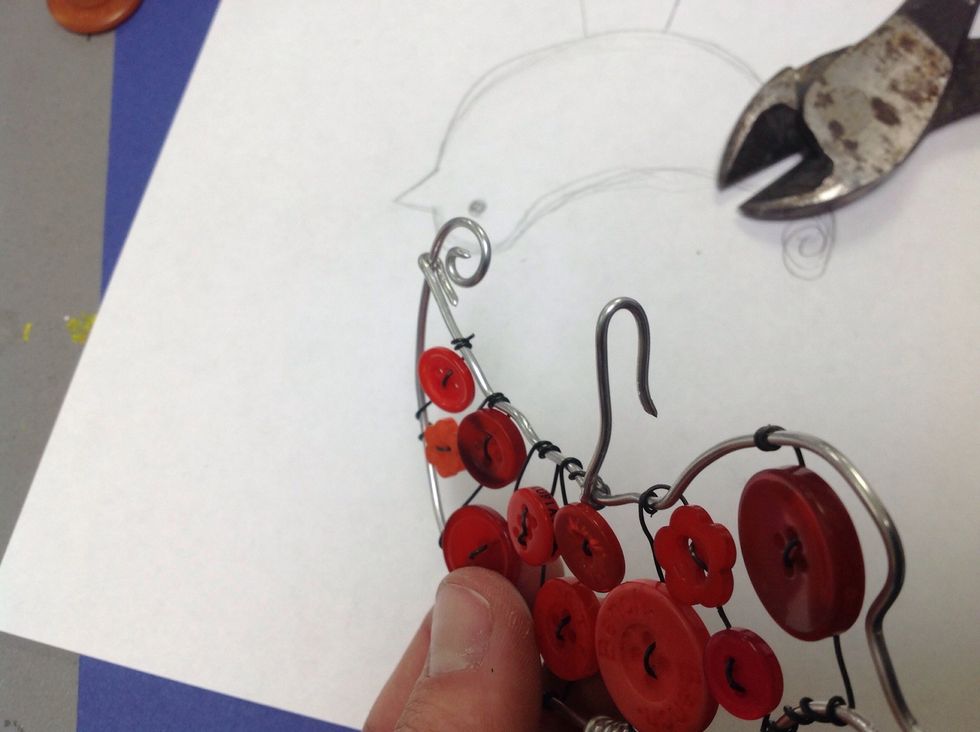 I cut a small piece of wire to use as a hook and attached it to the top of the bird.