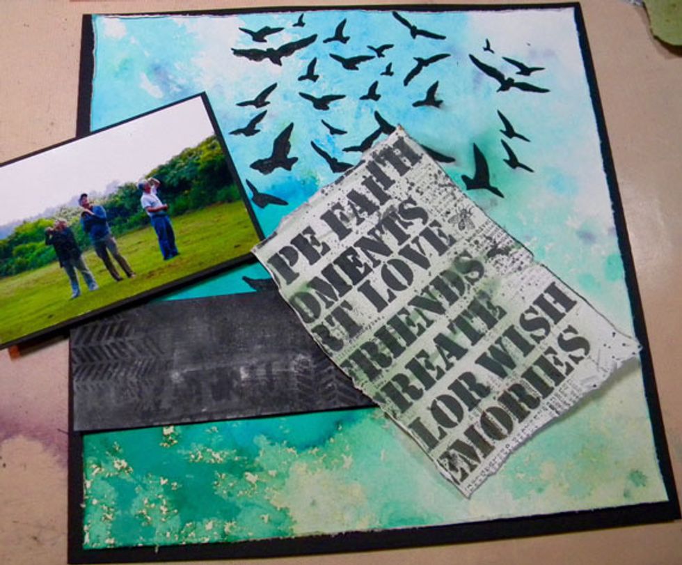 I cut apart my handmade patterned paper and found some images that worked with my layout. I added a black cardstock mat to my photo and sprayed more Raider onto one of the papers.