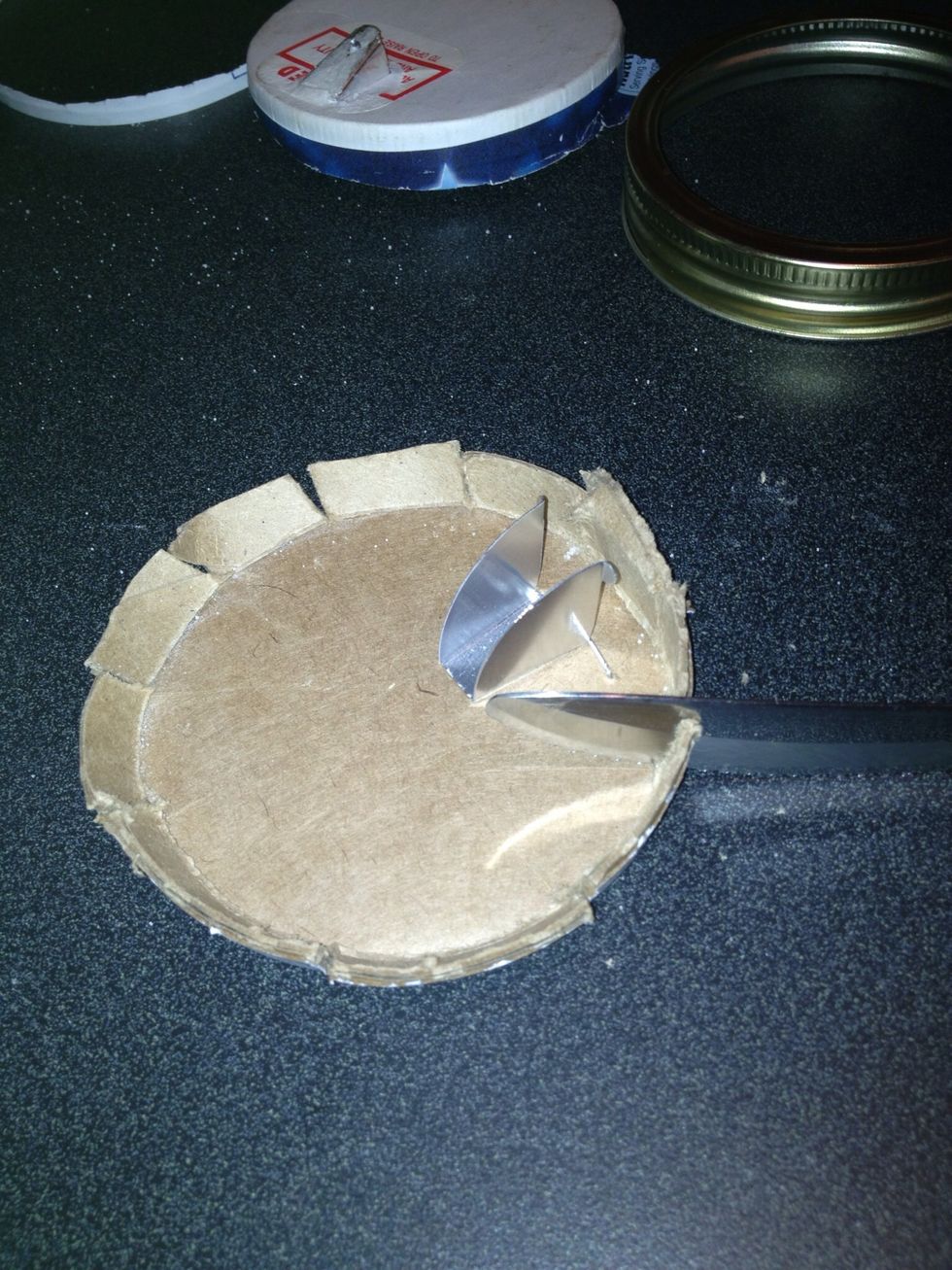 I cut around the edge of the lid with my knife so that it would be flexible and easier to cut around the edge with my scissors. The size of the box top and the jar lid are a perfect fit.