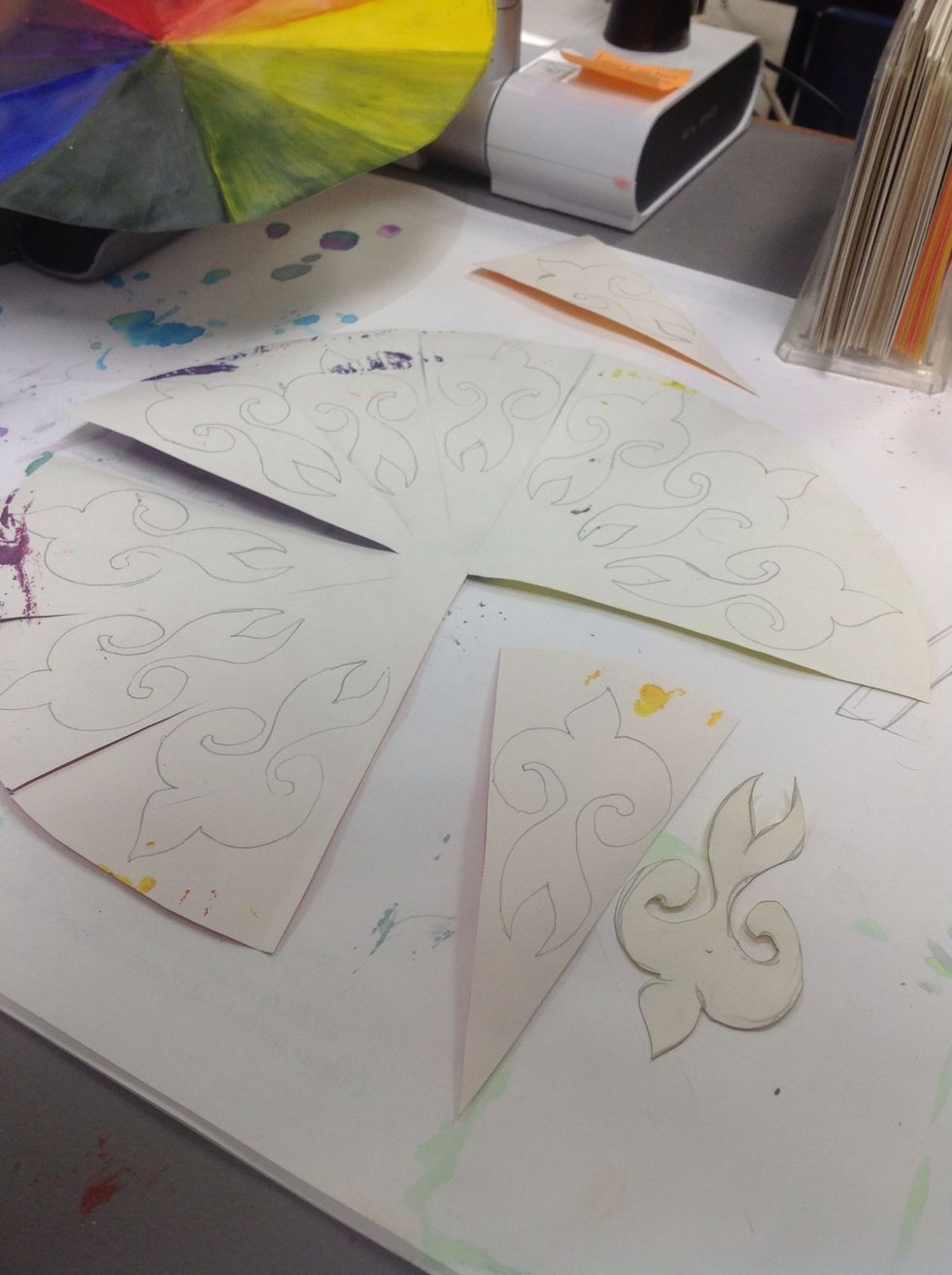 I cut into my color wheel leaving the pieces connected in the center and then traced all. It helps with organization.