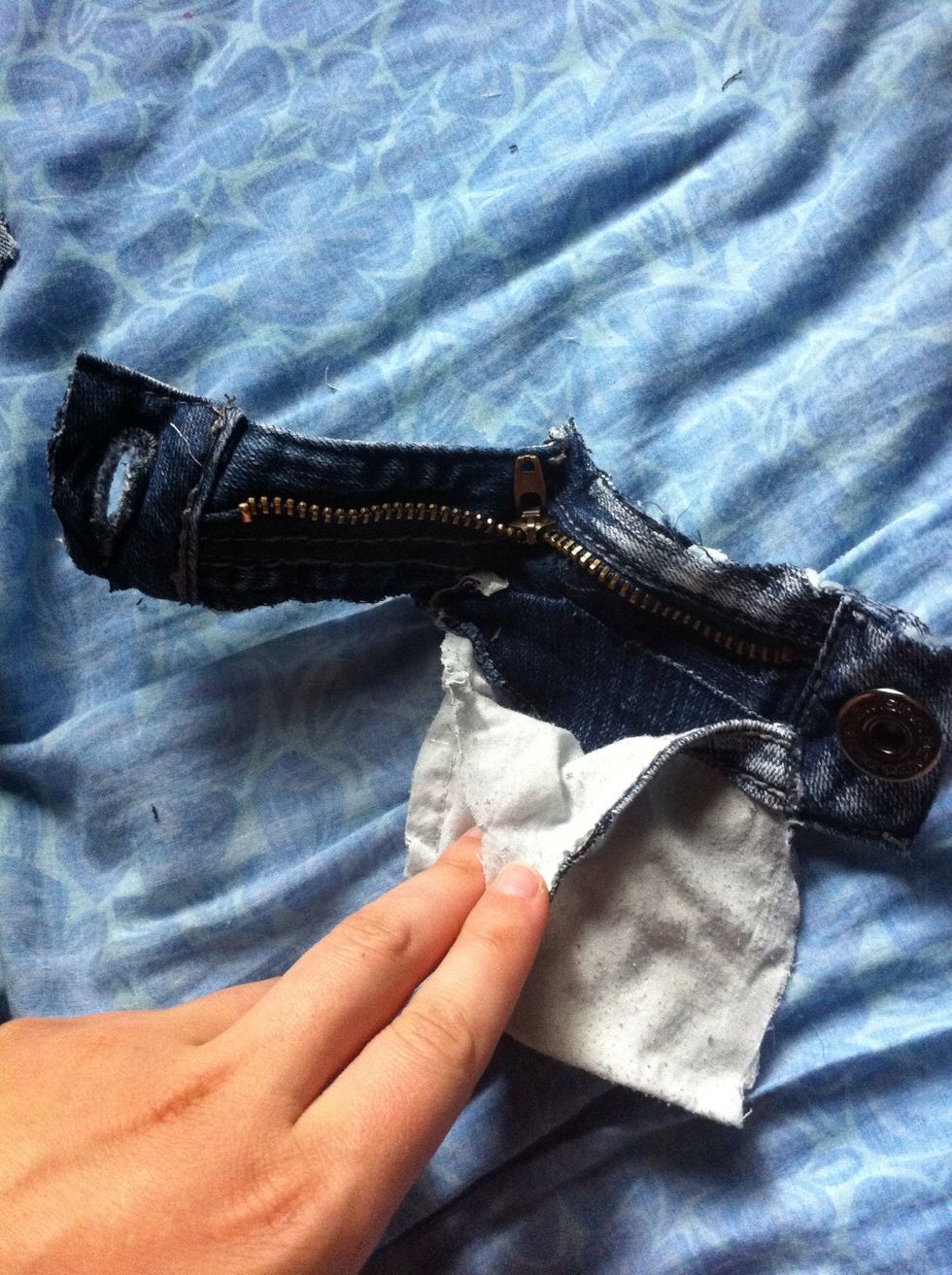 I cut out a pocket from the jeans and hot glue-gunned it to the front zipper! \u2702\ud83d\udcaa
