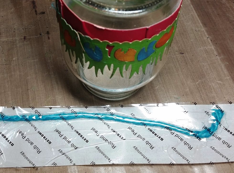 I cut out a section of turquoise rope to fit the bottom of the jar and used the 1.5 sticker maker to adhere it to the jar. I did the same to the top of the jar with the pink rope.