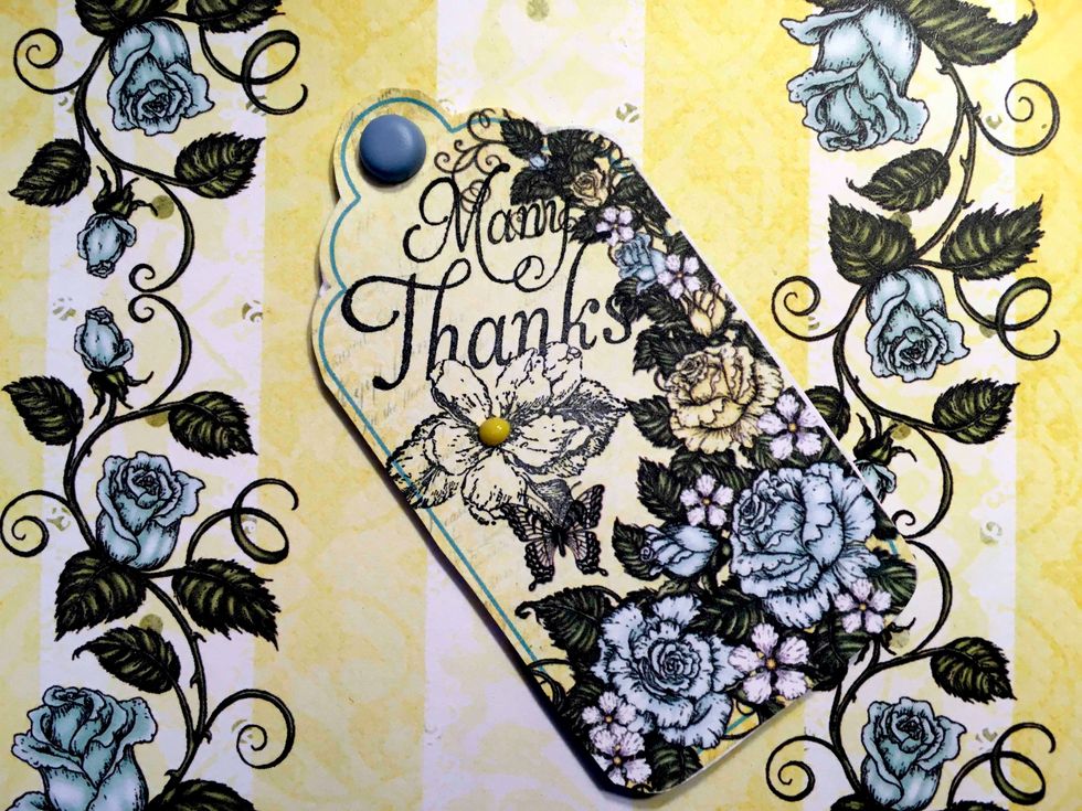 I cut out this tag that was in the Heartfelt Creations Blushing Rose and used a Graphic 45 stamp "Many Thanks"  I added a blue brad and this was glued to the first fold inside the card.