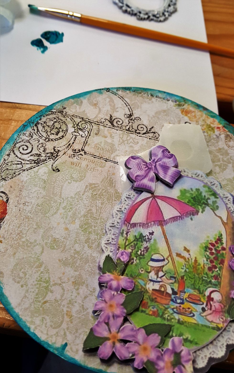 I cut the Blue Fern Studio paper to the embroidery loop size and glued it. Later I used some steal blue acrylic paint to distress the edges glued to the smaller loop.