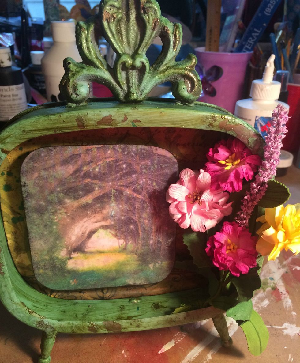 I cut the flowers that I wanted to use from the garland, then wired them together and glued them onto the right side of the frame with hot glue. I cut some longer flowers and glued them in as well