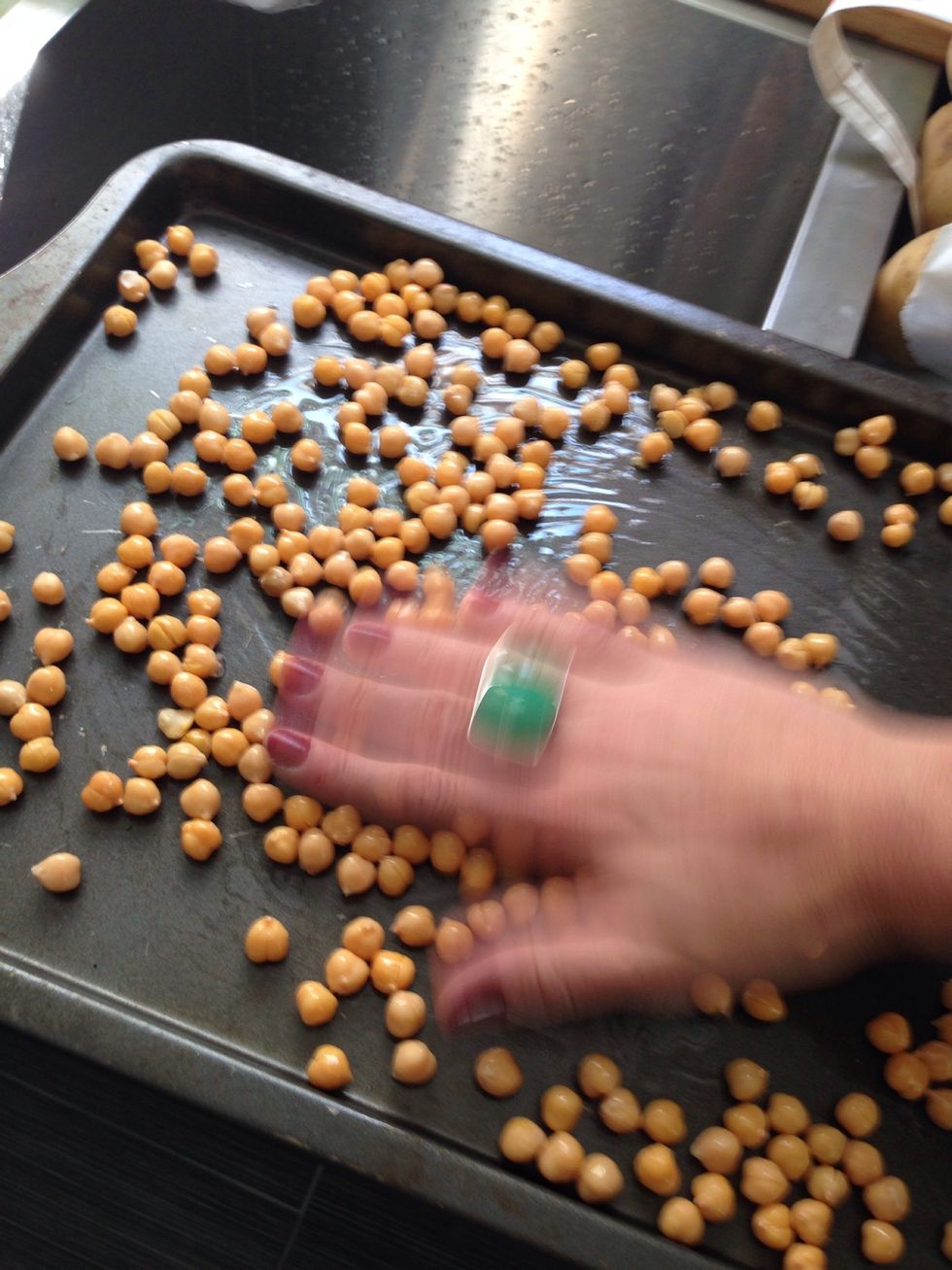 I'd rather give birth again without an epidural than peel skins off of chickpeas. Add a little olive oil and move the beans around in it. Pop em in the oven at 400 for 20-30 min.