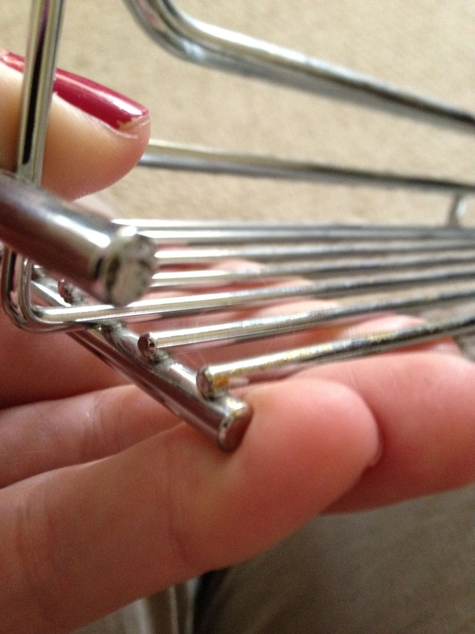 I decided I should break off the 2 metal pieces that were not attached to the side brackets.  This would provide more support, and be more secure for the polish bottles on the rack.