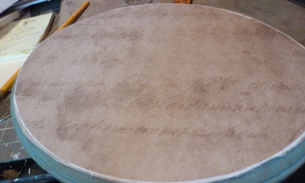 I decided to add paper to the front of the plaque. Easy wait to get a perfect fit on the plaque is to hold the paper in place on top with one hand. With the other use an emery board.