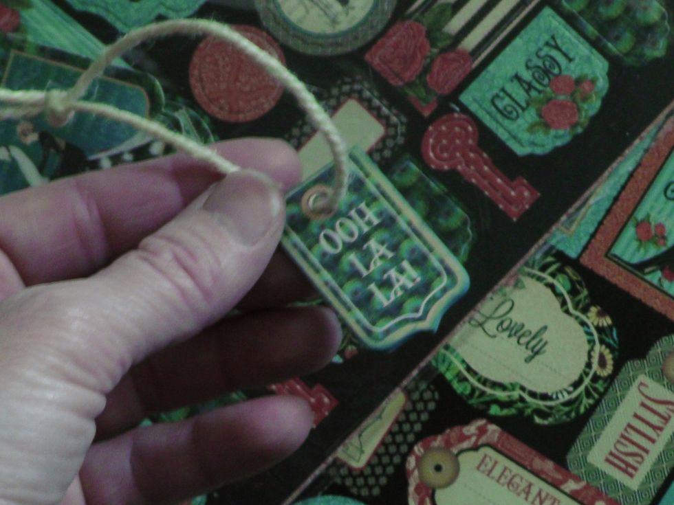 I decided to add some last minute embellishments adding some Graphic 45 Couture Chipboard tags and twine