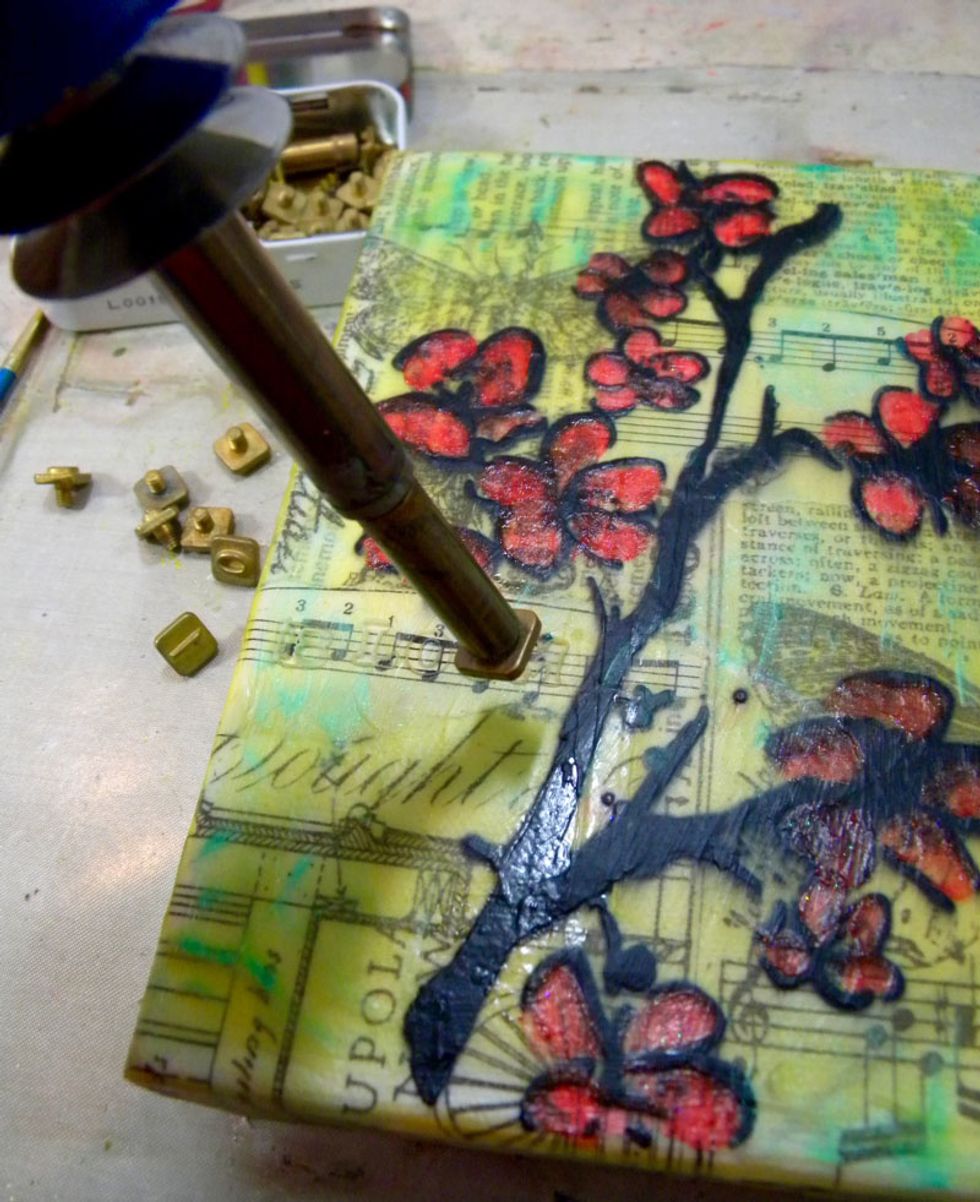 I decided to dust off one of my hoarded tools called the Hot Boss, which has interchangeable tips including letters, knives, and points that heat up. I used the letters to emboss into the background.