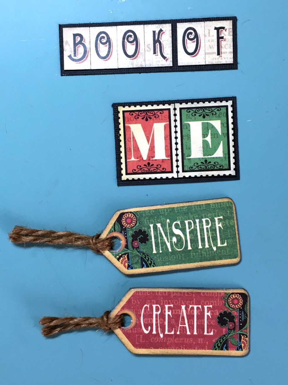 I decided to mount the letters on a piece of black cardstock so they'd stand out more. Loop some twine through the 2 chipboard tags shown.