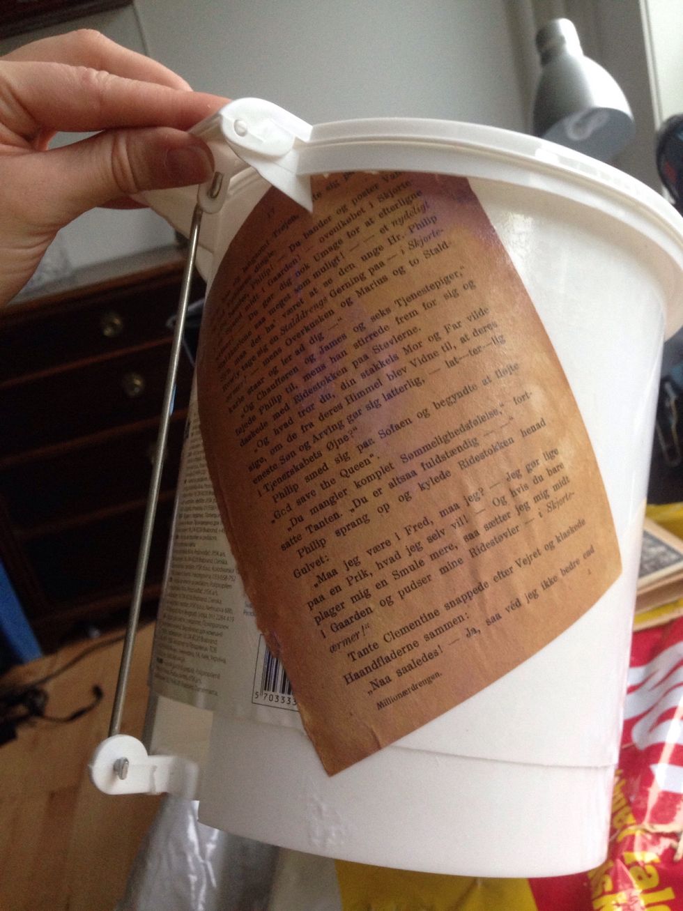 I decided to start at the back. I found it easiest to apply mod podge to the bin, then add the paper. And don't forget to soak the page in mod podge afterwards as well