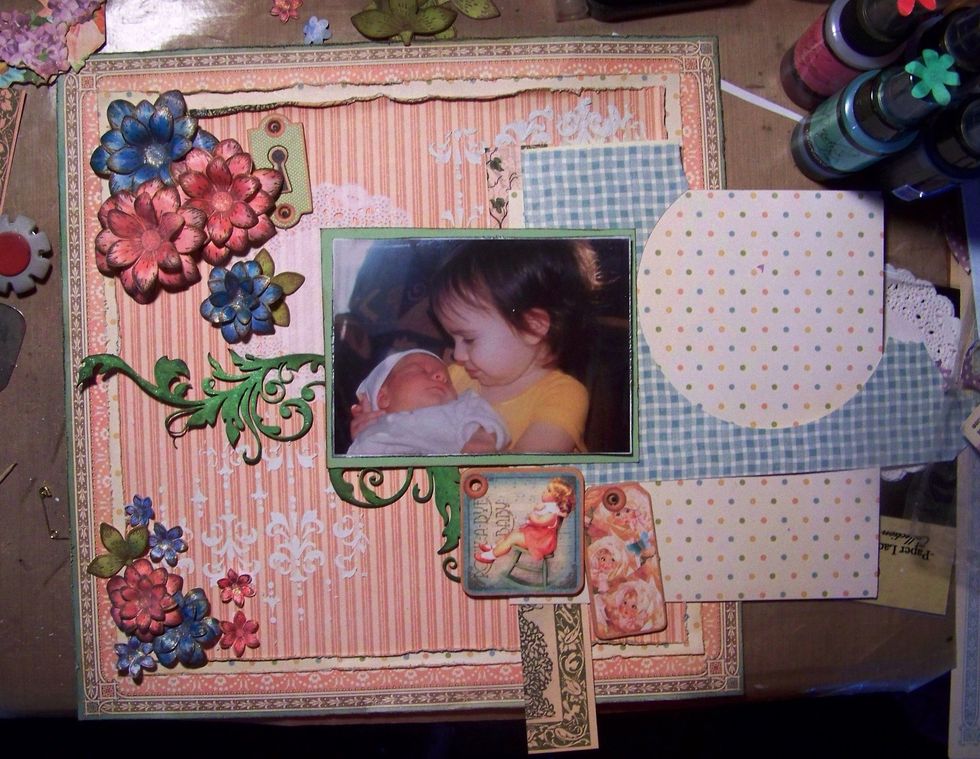 I do a dry placement to get an idea of where I want all my goodies. I use my smaller pieces and scraps of paper for layers under my photo. I take a pic so I remember where most of it goes.