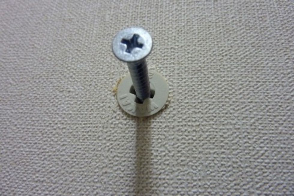 I drive an anchor into the wall.