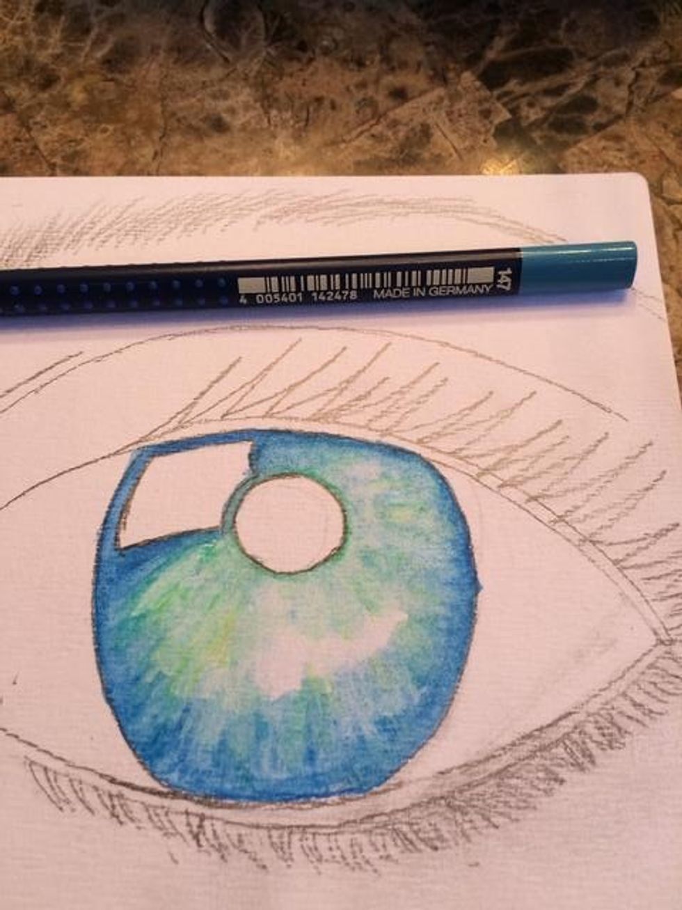 I felt my eye needed more depth, so I grabbed my Art Grip (R) Aquarelle Watercolor Pencil #147 again and added more of my dark blue around the edges. I then used my water and paintbrush to blend.