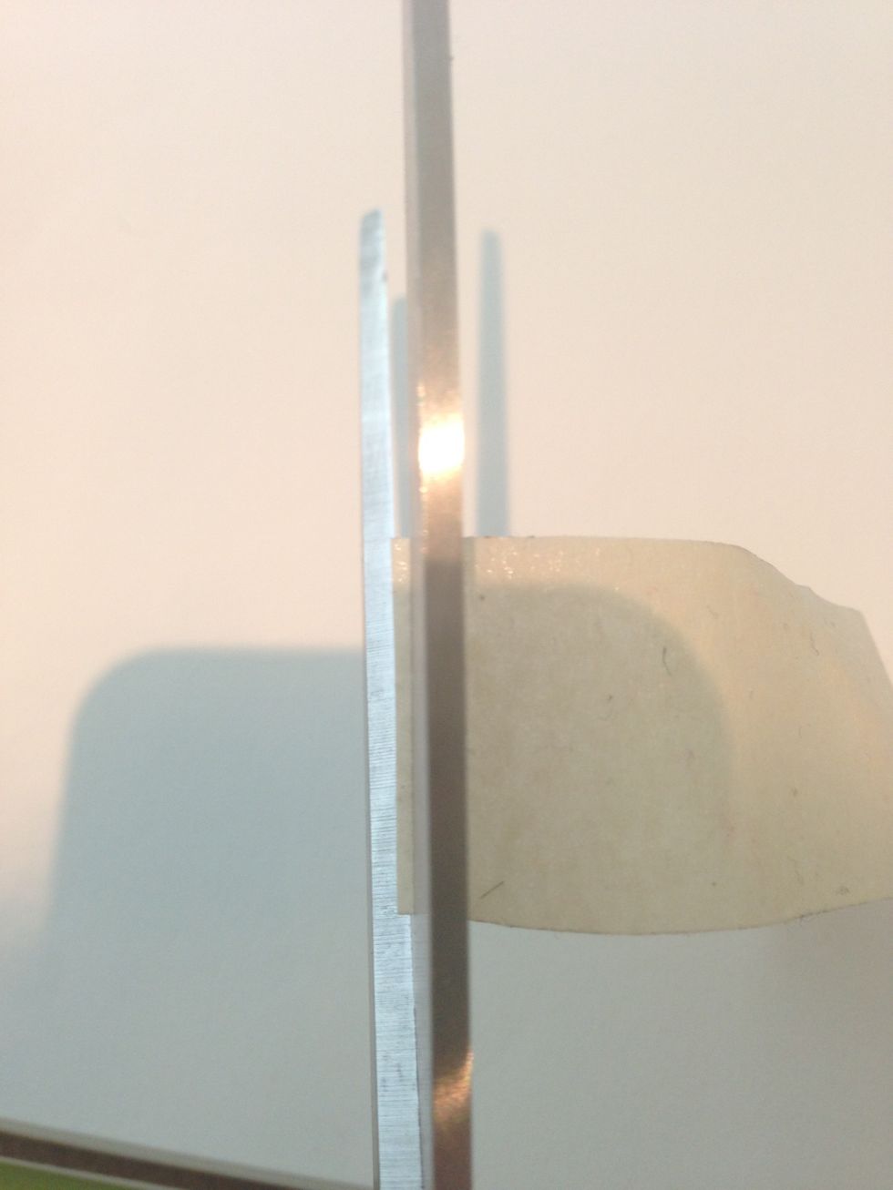 I find is easier to see if the tape is straight by turning the scissor over, this way you see what it will look like once it's cut.