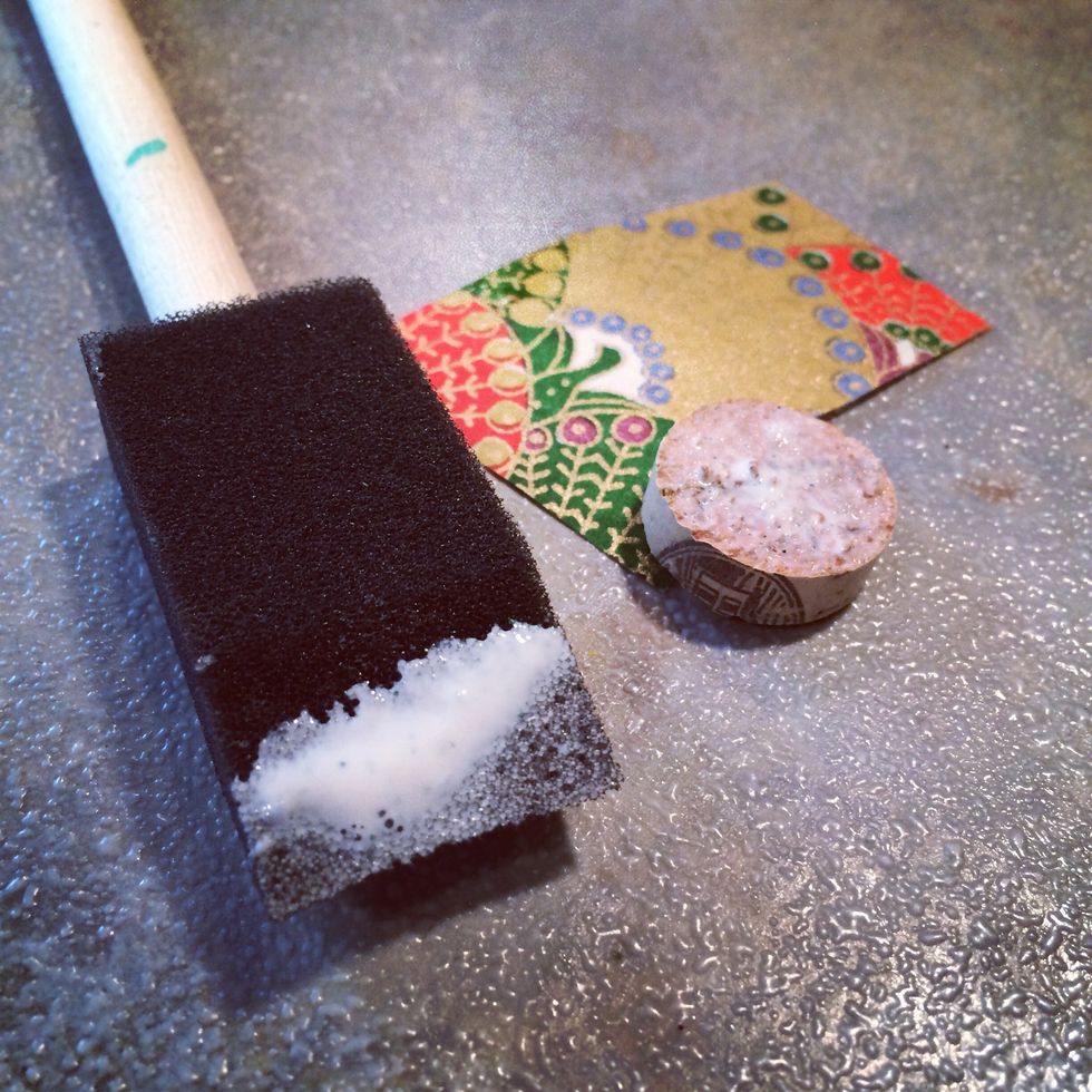 I find sponge brushes work really well when using Mod Podge. Add a coat of Mod Podge to the flat side of the cork round.