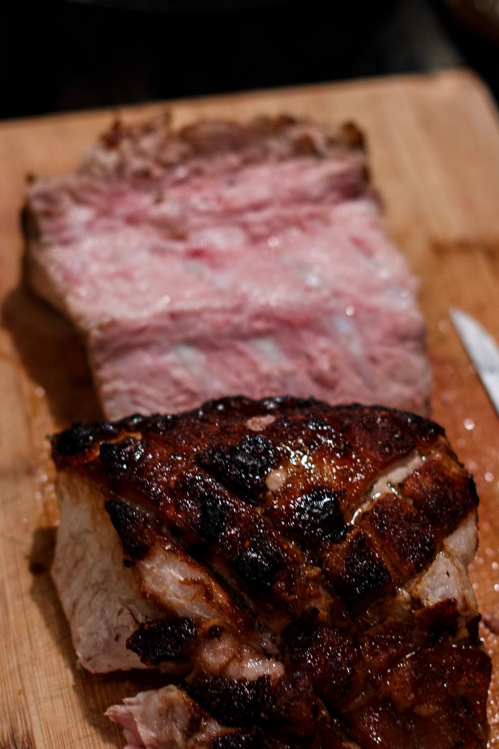I find the best way to serve this, is to slice the entire hunk of meat off of the bone. Just start at the top side and work your way down slowly. Use tongs and a knife so you don't burn your hands.