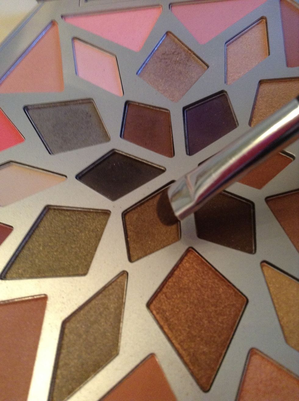 I find the liner on its own looked flat, so I am going to reach for a shimmery brown shadow to push into the center of my smudged line ...