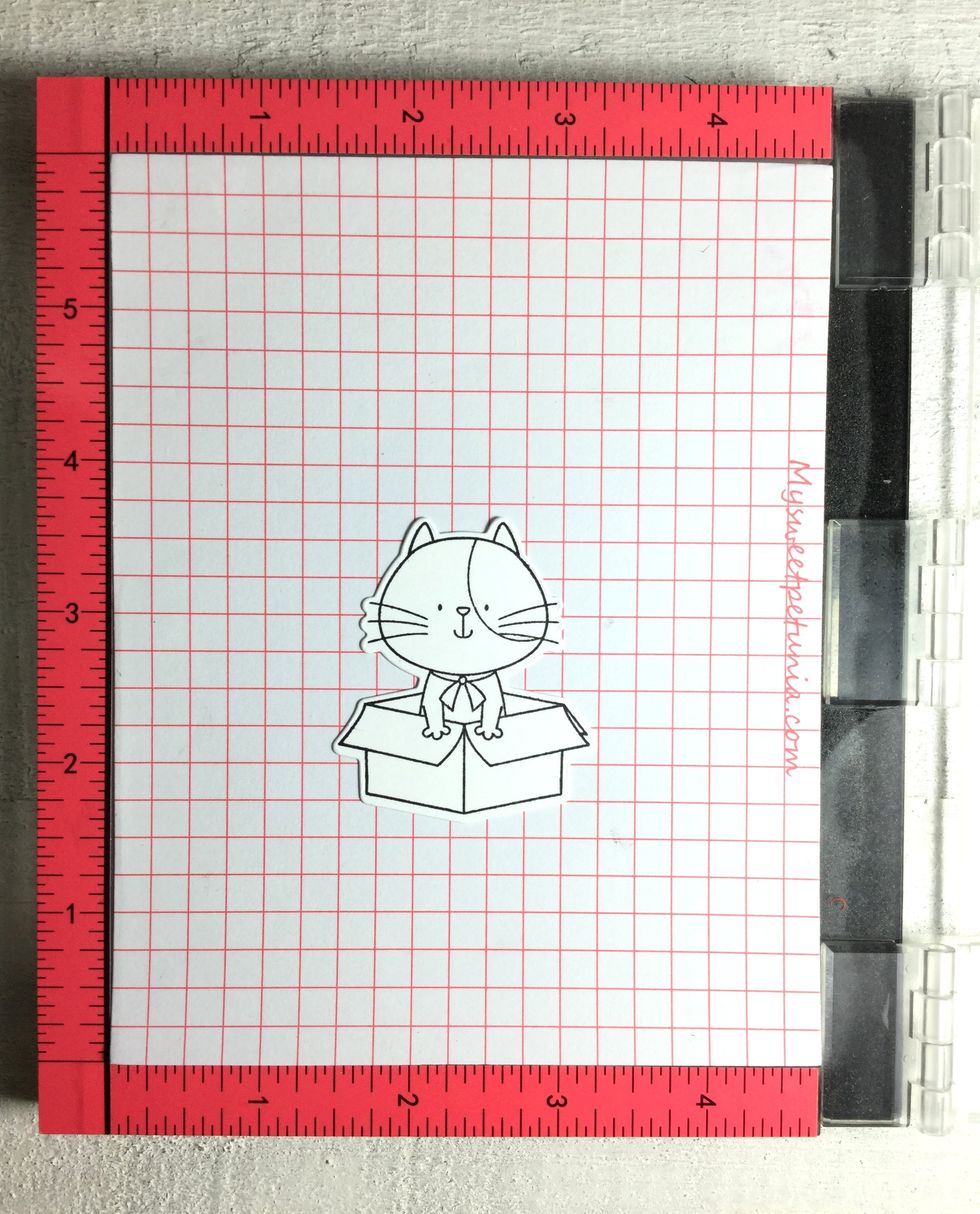 I first die-cutted the little cat and stamped it on the die-cut. I used a little bit of tape to keep the die-cut in place while I did the stamping. The Misty came out very handy again.