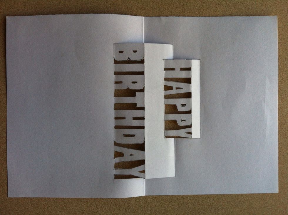 I forgot to take a photo before cutting it, but basically draw this design on to one of the pages and cut out the letters and the sides, but make sure you don't cut the horizontal lines.