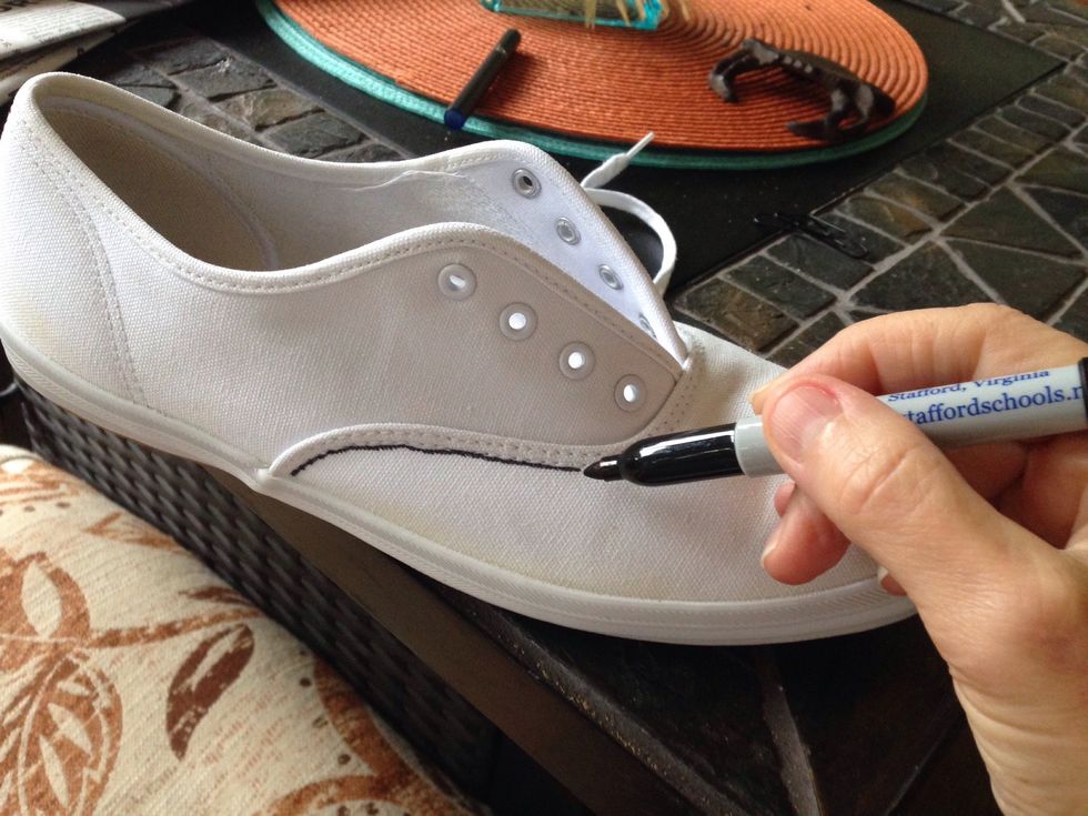 I found an old pair of white sneakers in the back of my closet.  I tried washing them but they still looked stained and boring.  So I pulled out some permanent markers and started doodling.