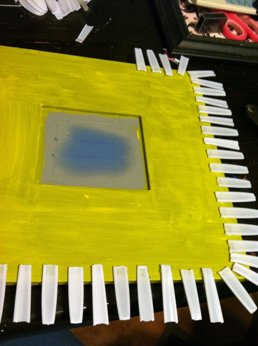 I found an old wood frame with a mirror in the center. Cover the mirror with blue painters tape, lightly sand the wood, and paint in desired color.