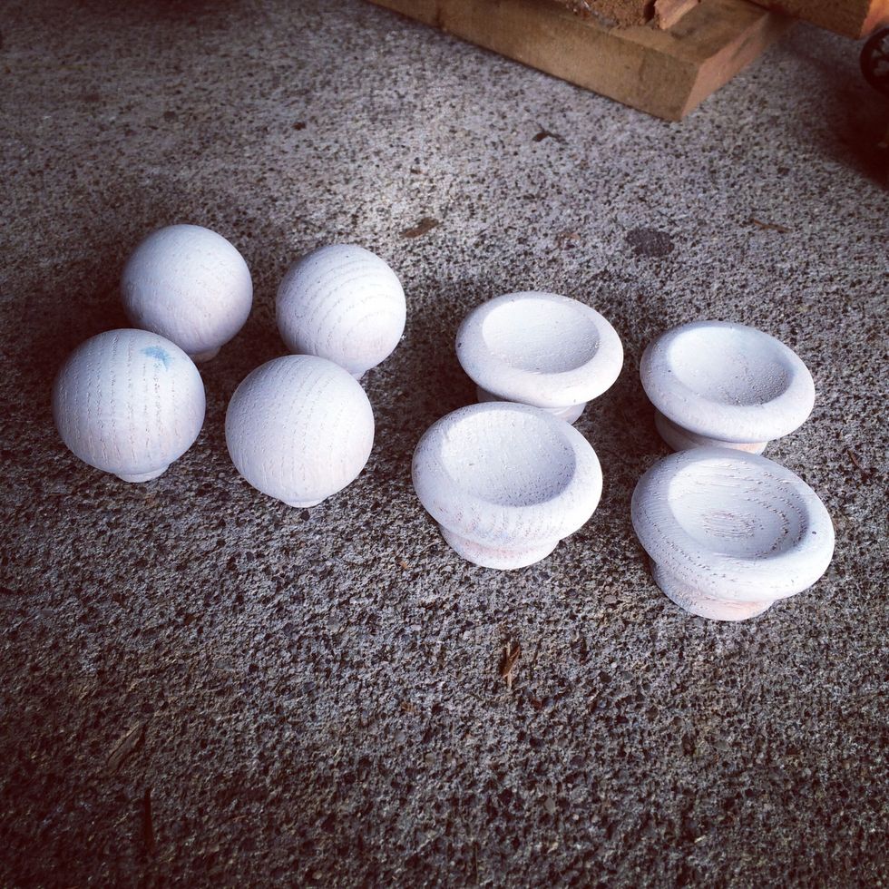 I found these plain wooden drawer pulls at the Habitat for Humanity ReStore. They were $0.25/each. First step for making them pretty - I added a coat of primer.