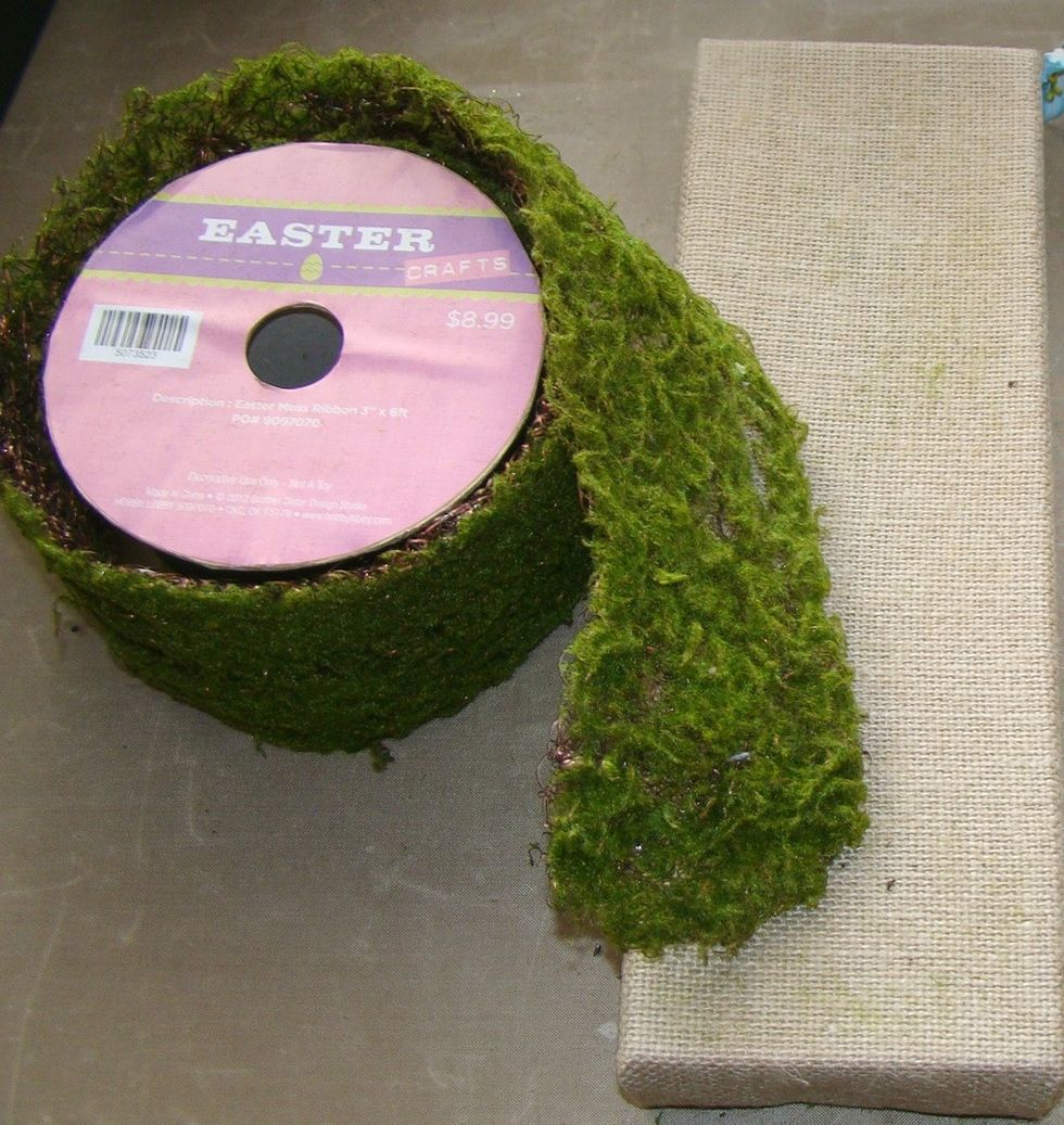 I found this cool wired grass at my local craft store. Measure your piece and using adhesive and glue gun, adhere it to your canvas. It provides a nice texture for your background.