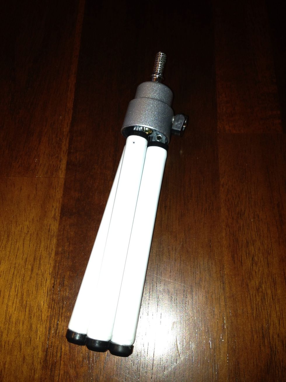 I found this travel tripod at a Dollar Tree. I chose white to match the base piece but they also had pink or blue.