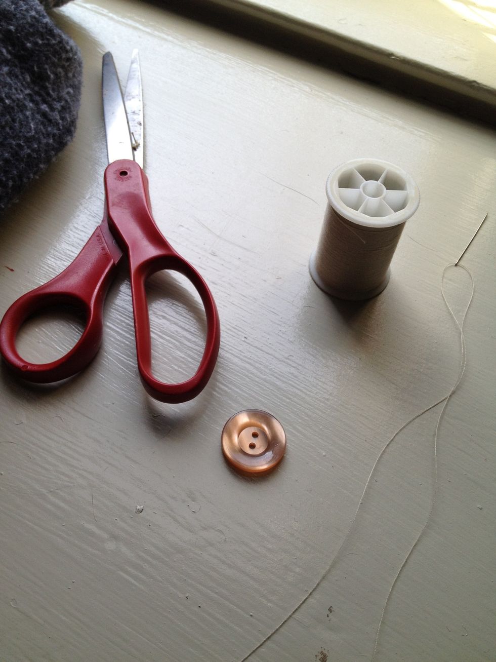 I found thread matching (or as close to) the existing thread for my coat. Cut about 12" or so and thread through your needle.